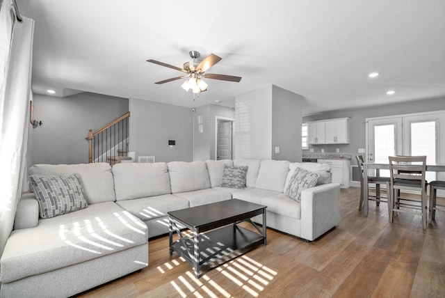 living room with hardwood / wood-style floors and ceiling fan