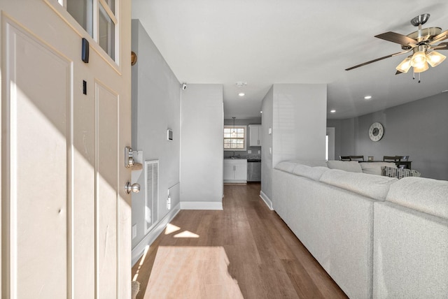 interior space with ceiling fan and hardwood / wood-style floors