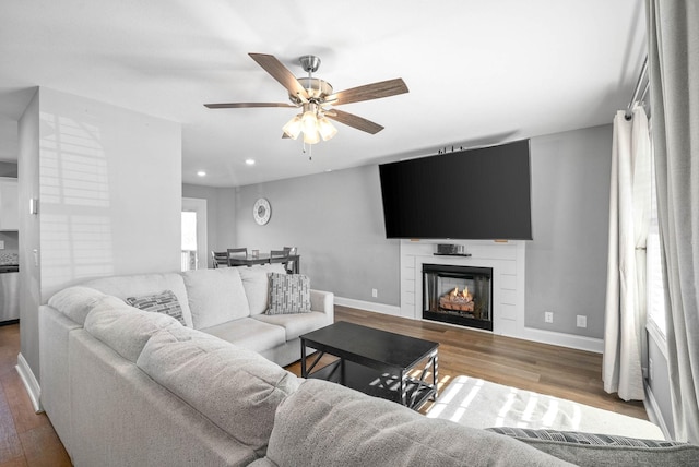 living room with hardwood / wood-style flooring and ceiling fan