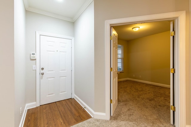 doorway to outside featuring light hardwood / wood-style flooring and crown molding