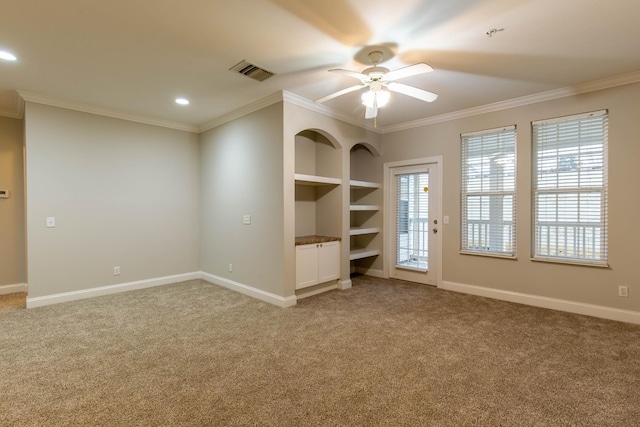 unfurnished bedroom with multiple windows, carpet flooring, access to exterior, and ornamental molding