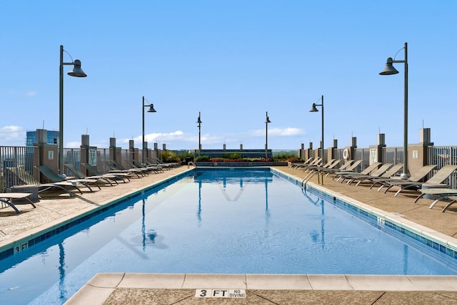 view of swimming pool featuring a patio area