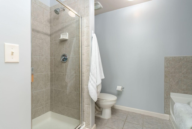 bathroom with a shower with door, toilet, and tile patterned floors