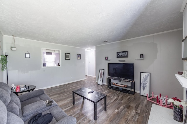 living room featuring a textured ceiling, crown molding, and dark hardwood / wood-style flooring