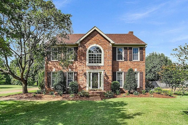 colonial home with a front lawn