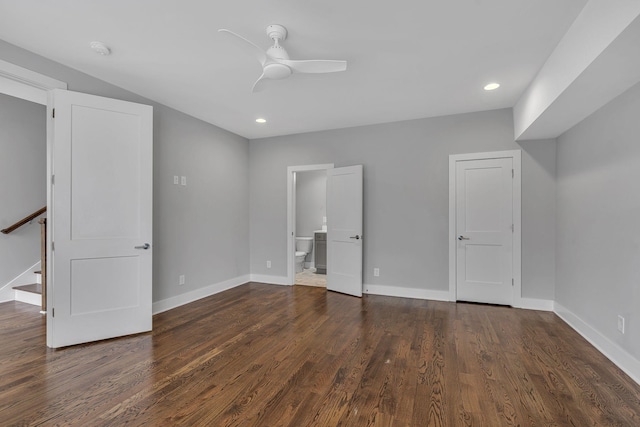 unfurnished bedroom with ensuite bathroom, ceiling fan, and dark hardwood / wood-style floors