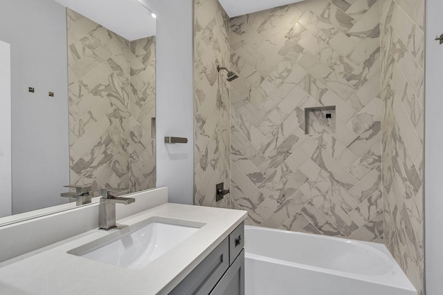 bathroom featuring tiled shower / bath combo and vanity