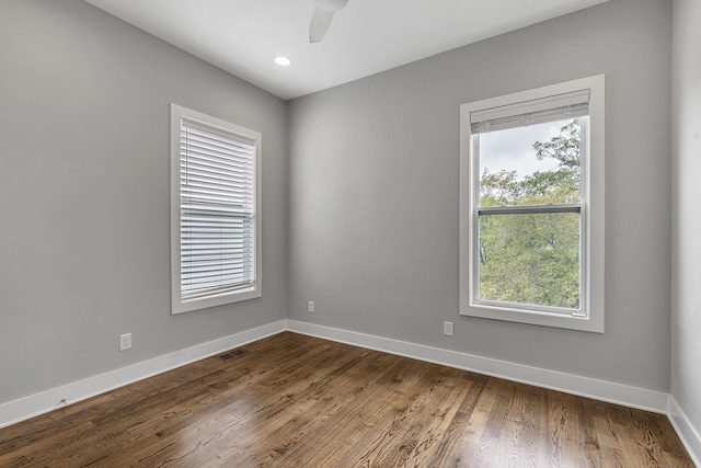 unfurnished room with dark wood-type flooring and ceiling fan