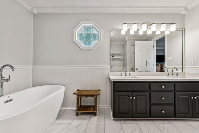 bathroom with vanity, a washtub, and crown molding