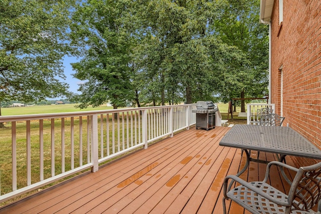 deck featuring area for grilling and a lawn