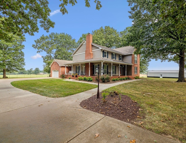 farmhouse featuring covered porch, a front lawn, and a garage