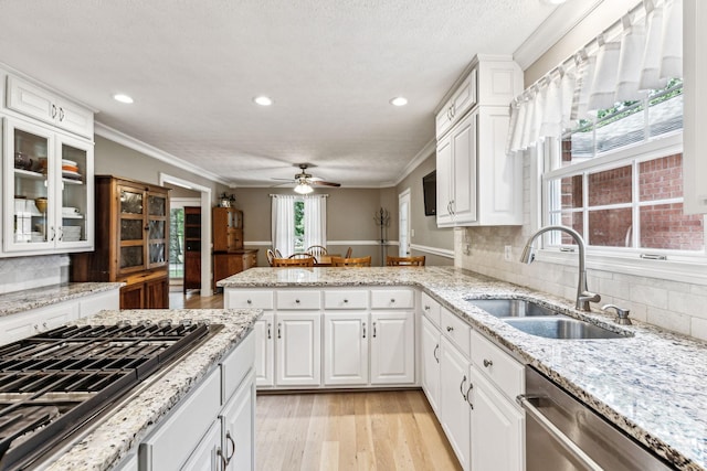 kitchen featuring sink, stainless steel appliances, crown molding, and white cabinets