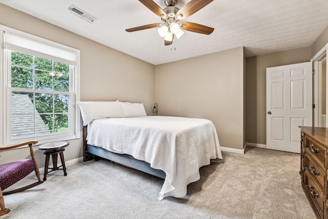 bedroom with light carpet and ceiling fan