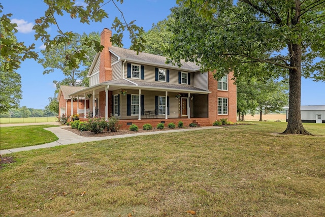 view of front of home featuring covered porch and a front lawn