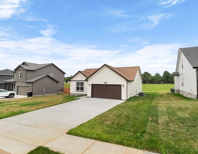 view of front of house featuring a garage, central air condition unit, and a front yard