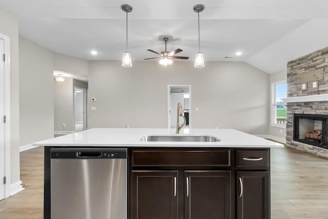 kitchen featuring an island with sink, pendant lighting, dishwasher, and sink