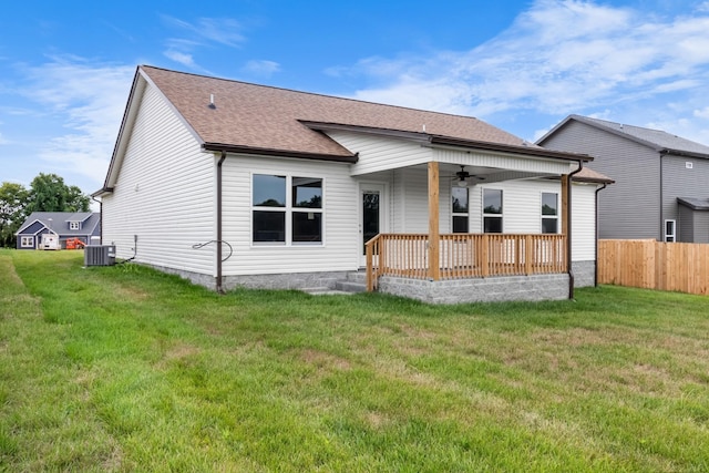 back of property featuring central AC unit, a yard, and ceiling fan