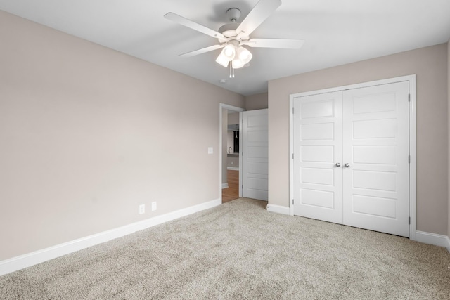 unfurnished bedroom with light carpet, ceiling fan, and a closet