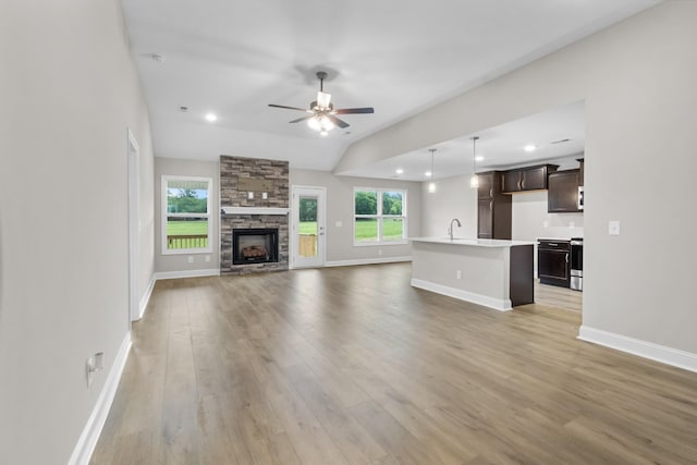 unfurnished living room with a healthy amount of sunlight, light hardwood / wood-style flooring, and ceiling fan