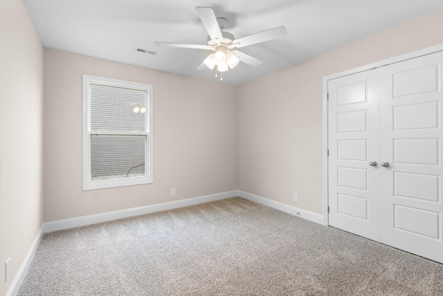 spare room with ceiling fan and carpet flooring