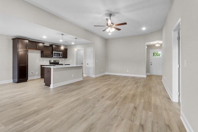 unfurnished living room with ceiling fan and light hardwood / wood-style floors