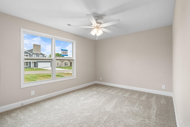 empty room with carpet and ceiling fan