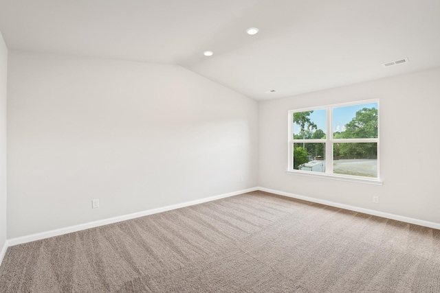 unfurnished room featuring vaulted ceiling and carpet