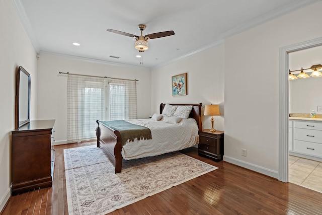 bedroom featuring ornamental molding, dark hardwood / wood-style floors, ceiling fan, and ensuite bath