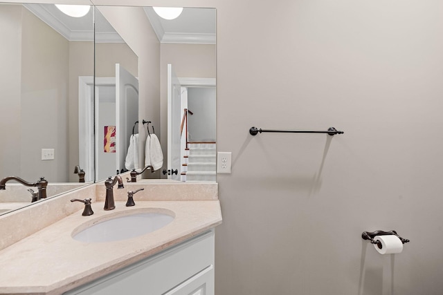 bathroom featuring ornamental molding and vanity