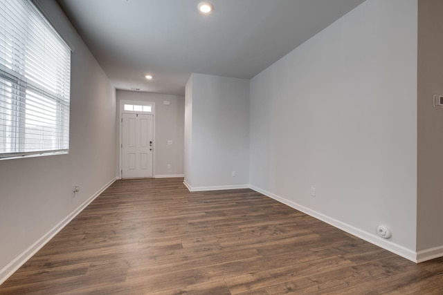 foyer entrance with recessed lighting, dark wood-style flooring, and baseboards