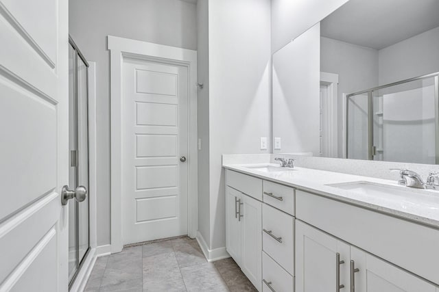 bathroom with vanity and a shower with door