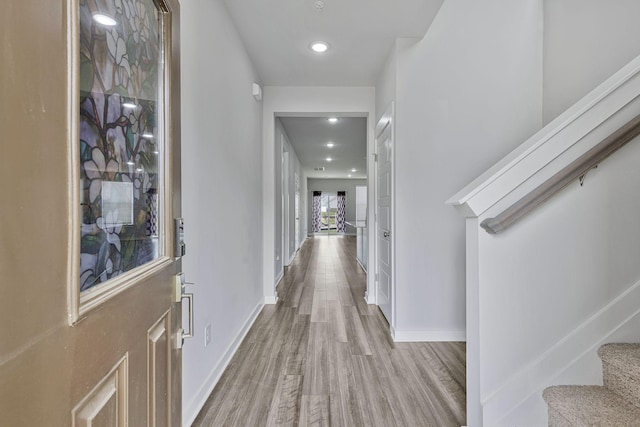 hallway with light hardwood / wood-style floors