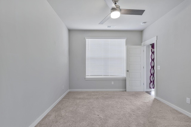 unfurnished room featuring ceiling fan and light colored carpet