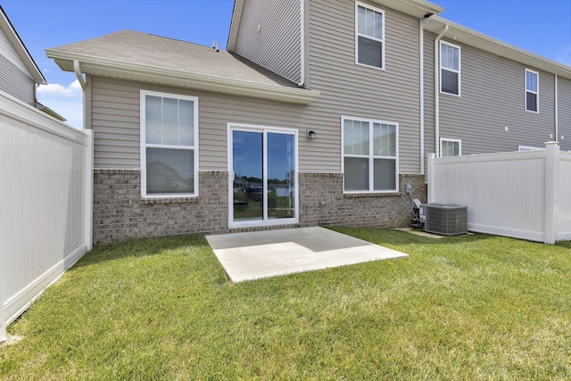 rear view of house featuring central AC, a patio area, and a yard