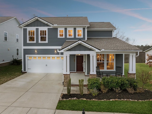 view of front of property featuring covered porch and a garage