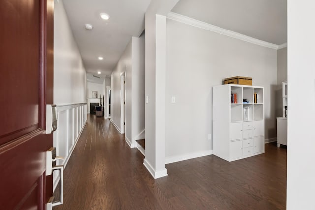 hallway featuring dark wood-type flooring and crown molding