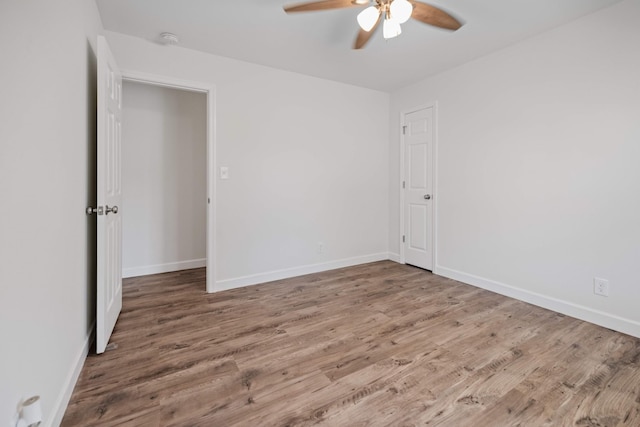 spare room with ceiling fan and hardwood / wood-style floors