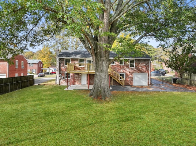 rear view of property featuring a wooden deck, a patio, and a lawn