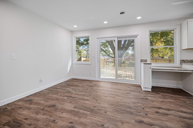 interior space featuring dark wood-type flooring and built in desk