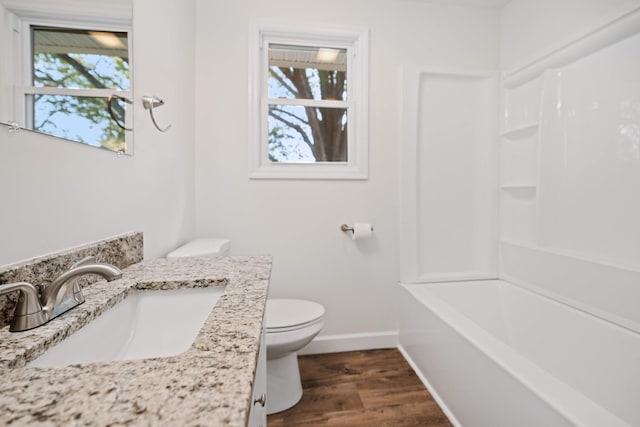 bathroom featuring hardwood / wood-style flooring, vanity, and toilet