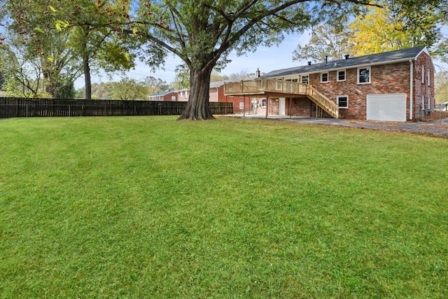 view of yard featuring a garage and a wooden deck