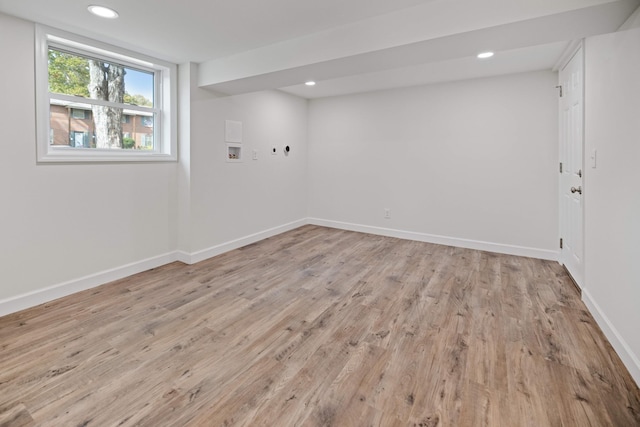 basement with light hardwood / wood-style floors