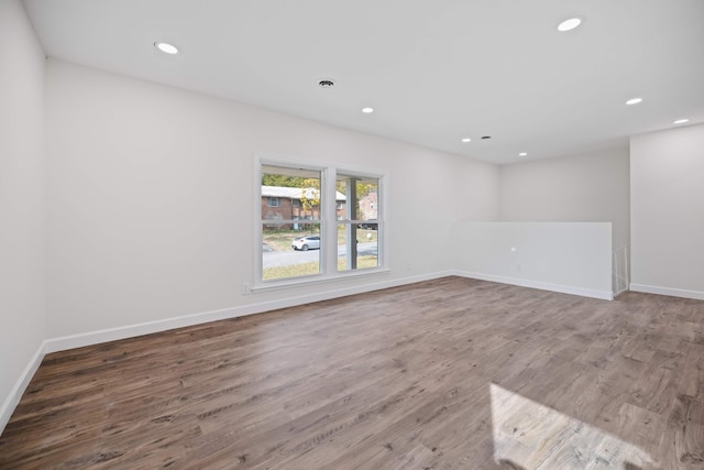 unfurnished room with wood-type flooring