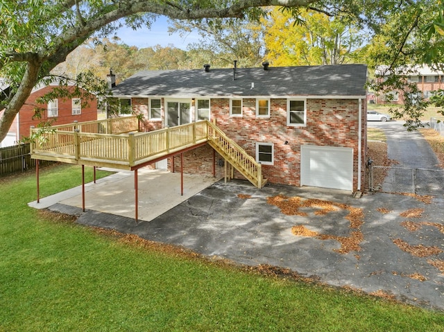 rear view of house featuring a garage, a yard, a deck, and a patio