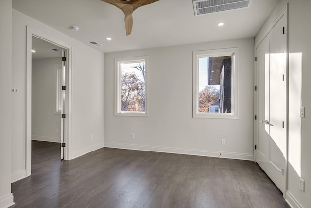 unfurnished bedroom with dark wood-type flooring and ceiling fan