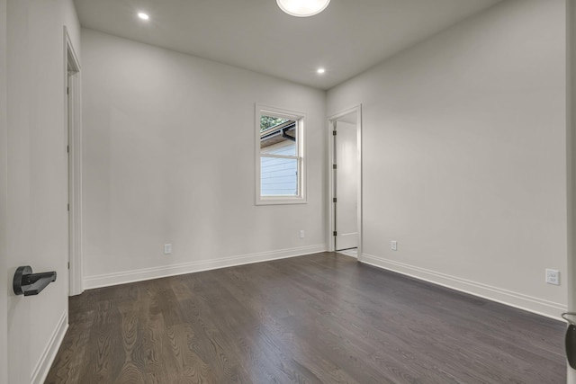 empty room with dark hardwood / wood-style flooring