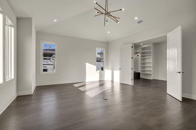 unfurnished bedroom with lofted ceiling, dark wood-type flooring, and a notable chandelier