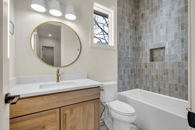 full bathroom with tiled shower / bath combo, vanity, and toilet