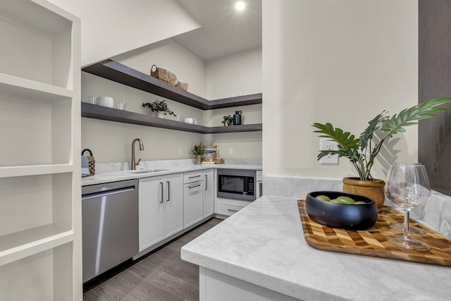 kitchen featuring sink, dishwasher, black microwave, dark wood-type flooring, and white cabinets