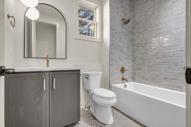 full bathroom featuring vanity, tiled shower / bath, and toilet